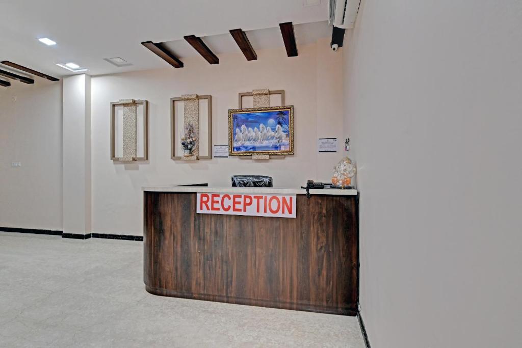 a reception desk in a room with a reception sign at OYO The Castle Home Stay Inn in Jaipur