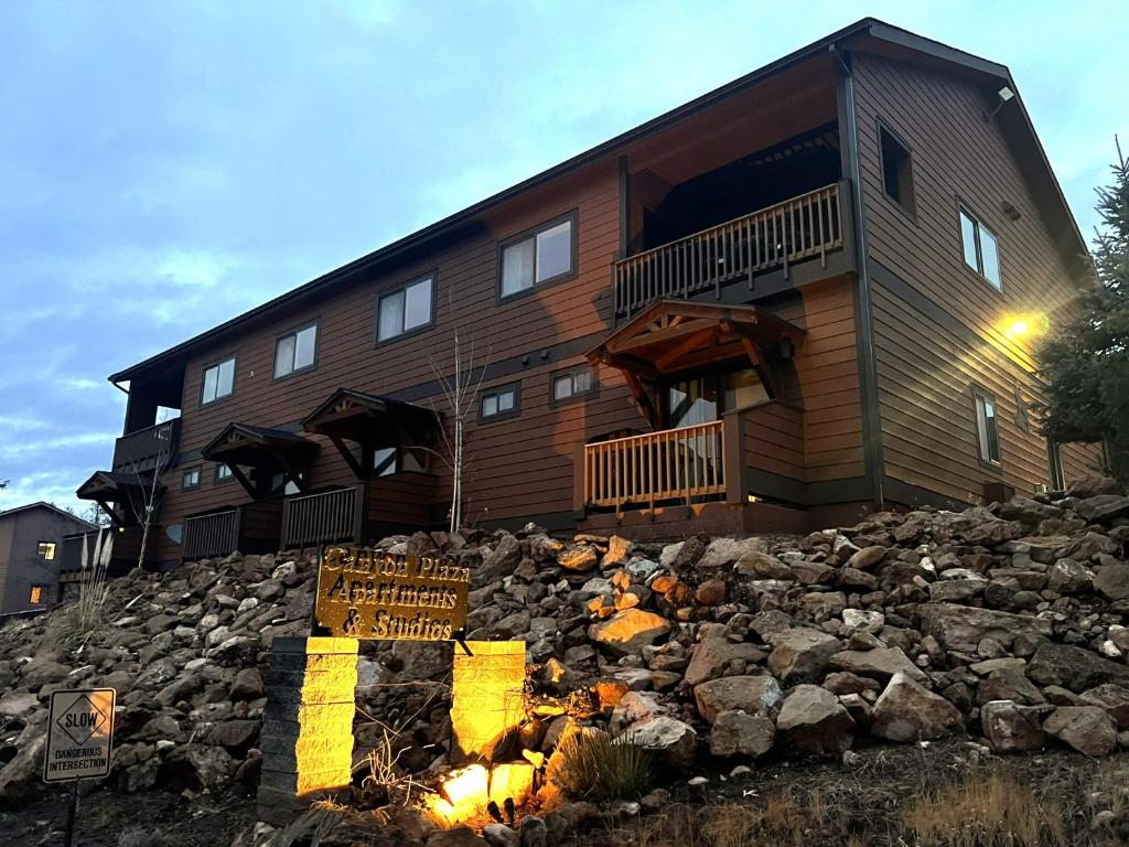 a house on top of a pile of rocks at Canyon Plaza Premier Studio and Apartments in Tusayan