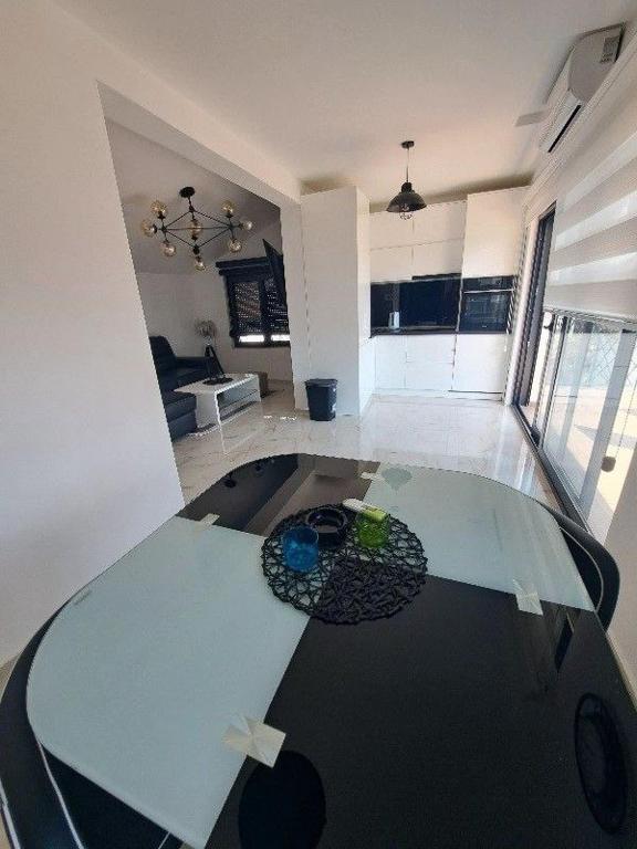 a living room with a glass table in a room at Vila Romantica in Budva