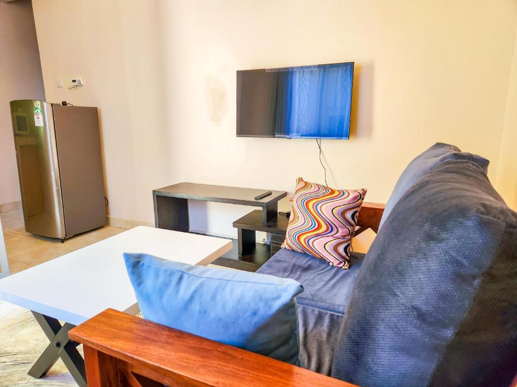 a living room with a couch and a table at Luxury Suites in Seeta