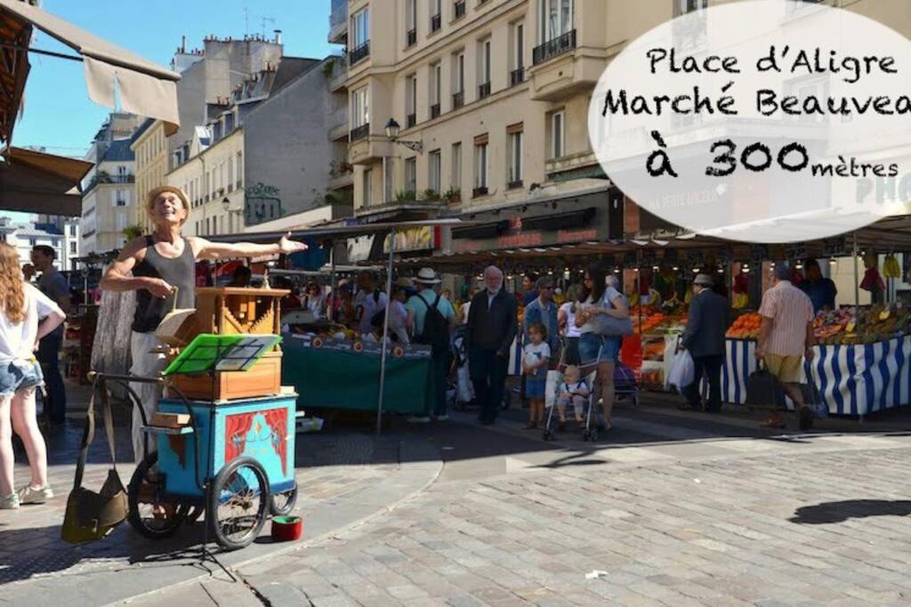 a woman standing next to a market with a sign at Magnifique appartement de charme au cœur de Paris in Paris