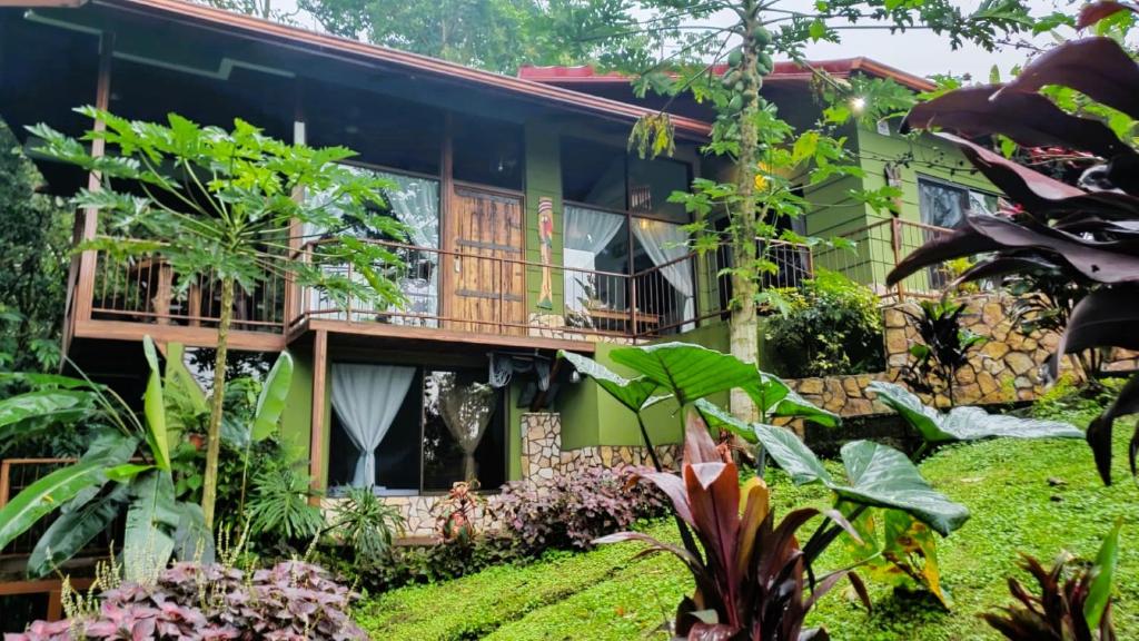 a house with a garden in front of it at La Fortuna Rainforest Glass Cabin With Suite in Fortuna