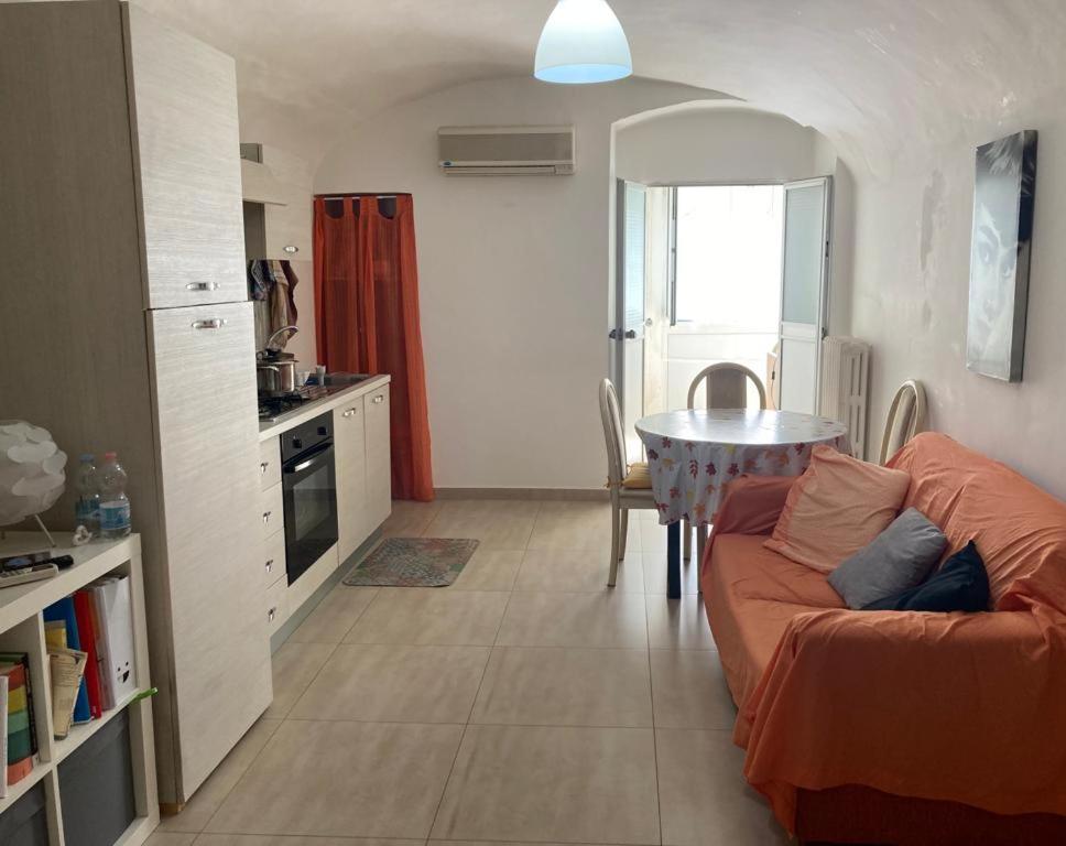 a kitchen and a living room with a couch and a table at appartamento due camere da letto al centro di Bari in Bari