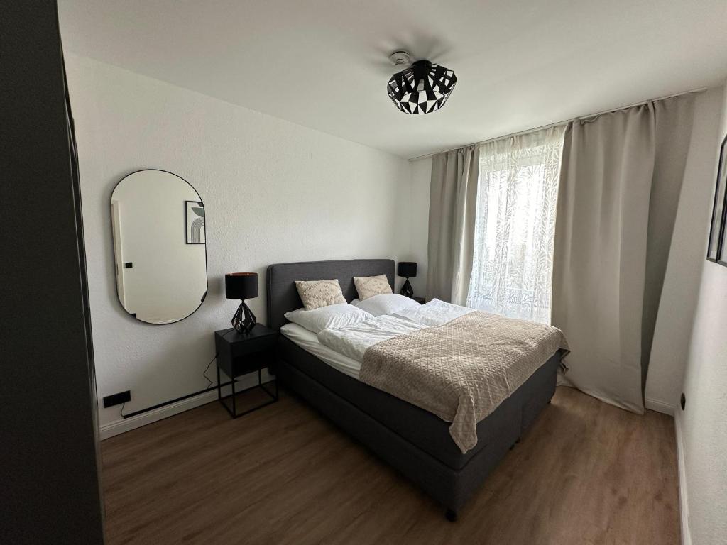 a bedroom with a large bed and a mirror at Haus Newgate in Lübeck