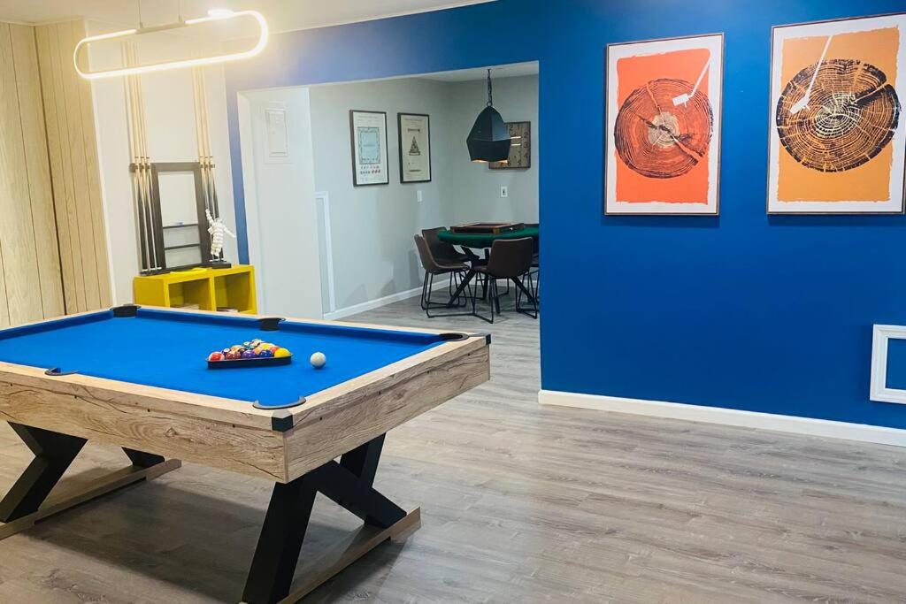 a room with a pool table and a blue wall at Beautiful Home with Bay View minutes from AC in Pleasantville