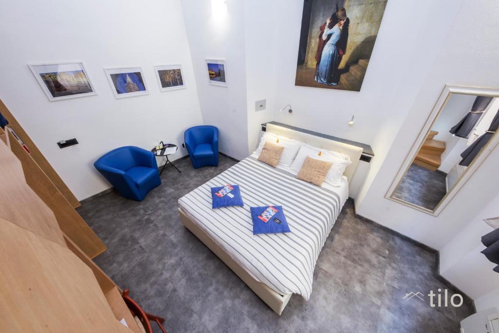 Postel nebo postele na pokoji v ubytování San Cosmo Suite
