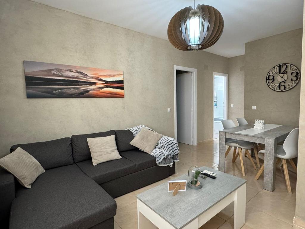 a living room with a couch and a table at Experience Valencia Bnb - Mare Nostrum Apartment Beach Puerto Sagunto in Puerto de Sagunto