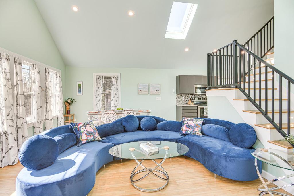 a large blue couch in a living room at Cozy Rhode Island Retreat with Yard, Near Beaches! in North Kingstown