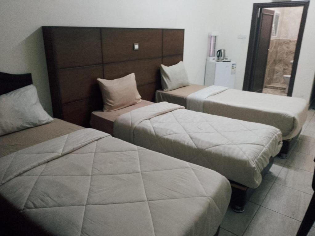 Ein Bett oder Betten in einem Zimmer der Unterkunft Amir Palace Hotel