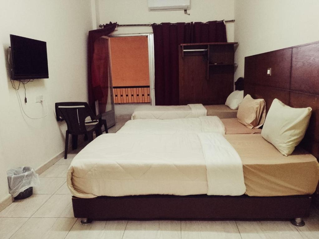 Ein Bett oder Betten in einem Zimmer der Unterkunft Amir Palace Hotel