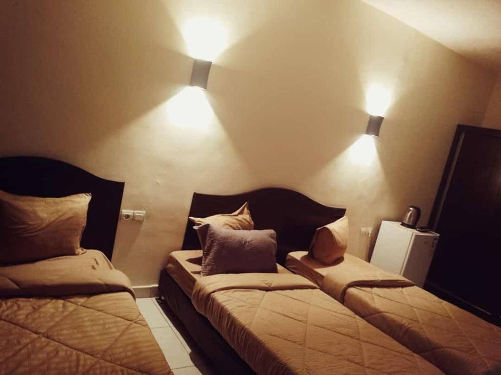 Ein Bett oder Betten in einem Zimmer der Unterkunft Amir Palace Hotel