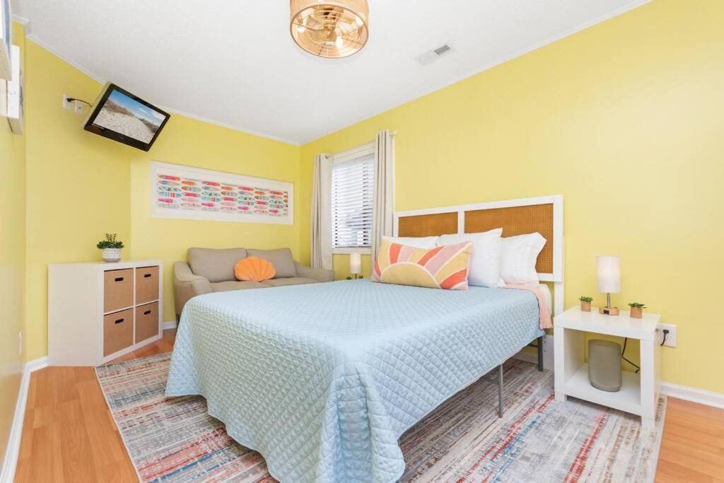ein Schlafzimmer mit einem großen Bett und einem Sofa in der Unterkunft Sunny Daze Beach Condo in Myrtle Beach