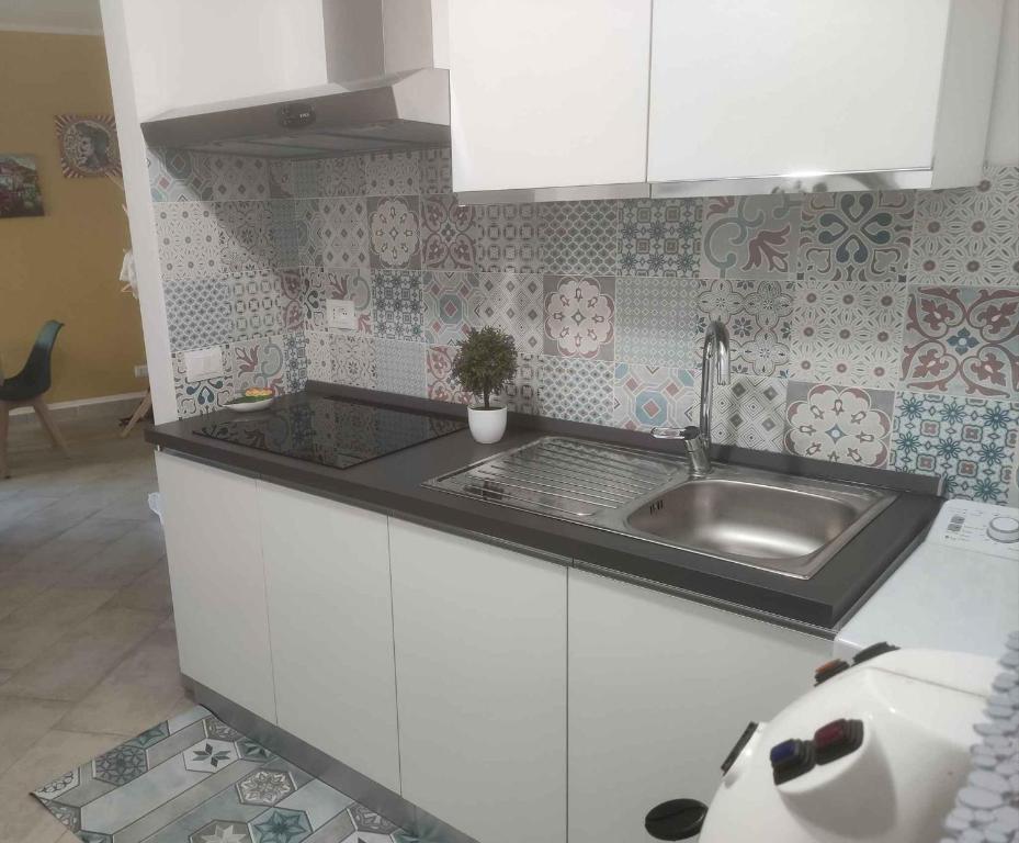 a kitchen with white cabinets and a sink at Holiday home in Caccamo - Sizilien 49210 in Caccamo