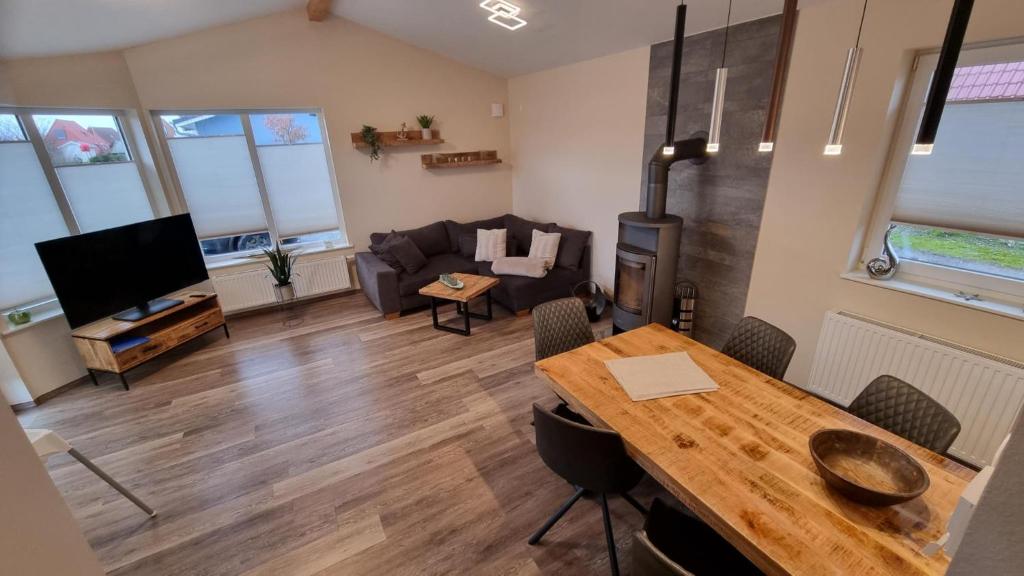 a living room with a table and a couch at Ferienhaus Strandengel in Dorum Neufeld