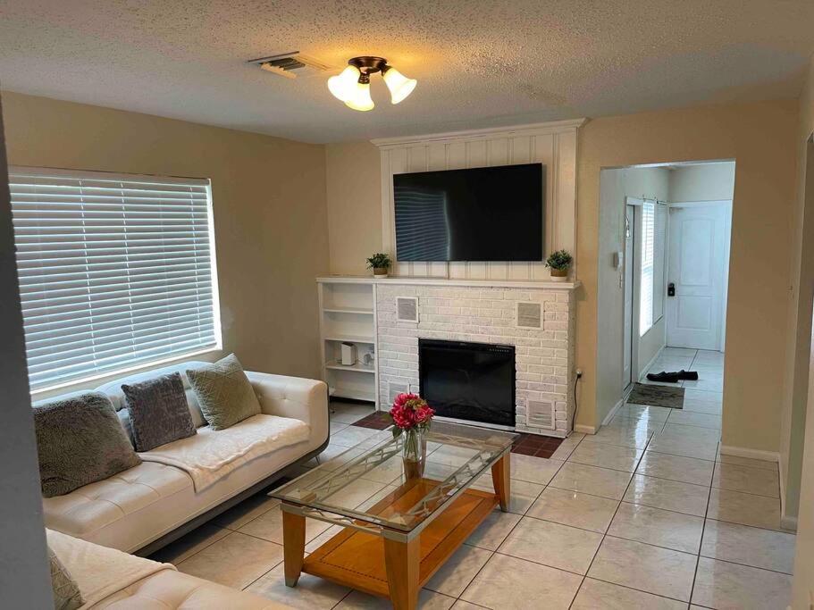 a living room with a couch and a fireplace at 2 Bedroom House, Ideal for a Family in Fort Pierce