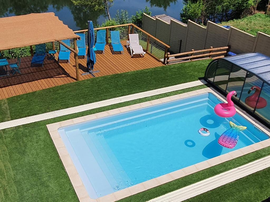 a swimming pool with a toy flamingo and a float at Gîte familial avec piscine privative chauffée, terrasse sur le Loir et proche du Zoo de La Flèche - FR-1-410-329 in La Flèche
