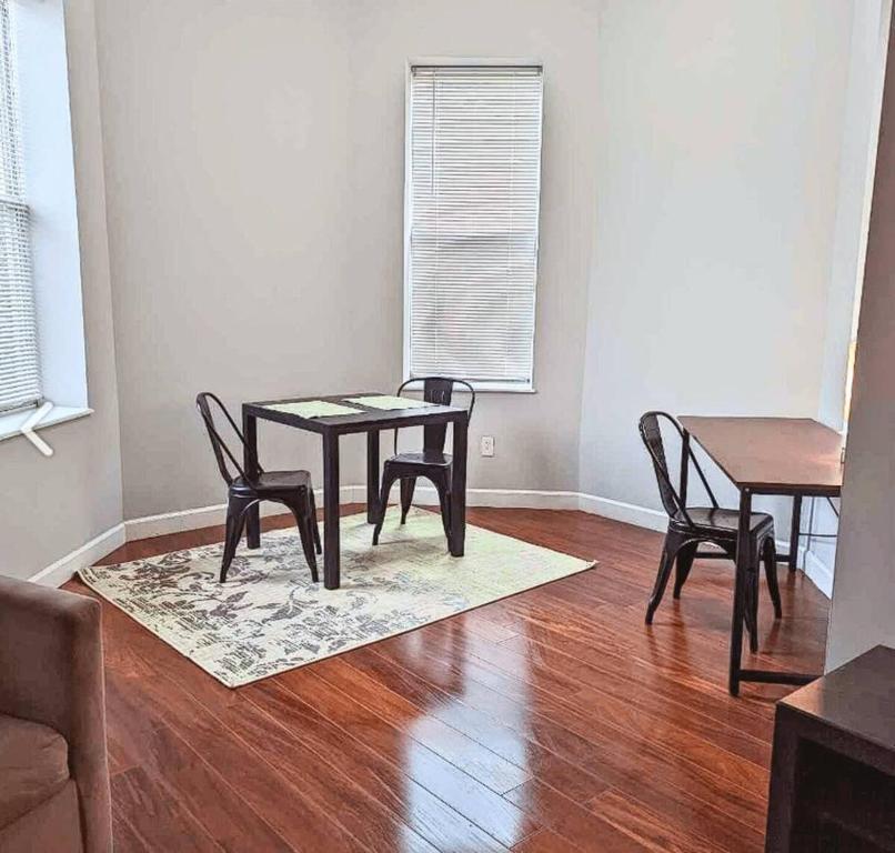 a dining room with a table and chairs on a wooden floor at 1BR W&D Near BJ Hospital Forest Park Zoo in Tower Grove