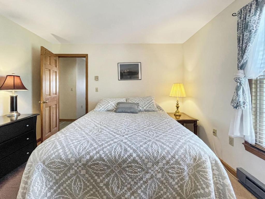 um quarto com uma cama grande e 2 candeeiros em High View at Short Sands condo em York