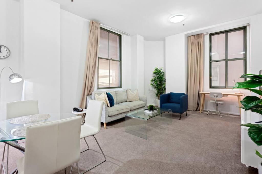 a living room with a couch and a table at Inner City Retreat 1BD Pyrmont - 302 in Sydney