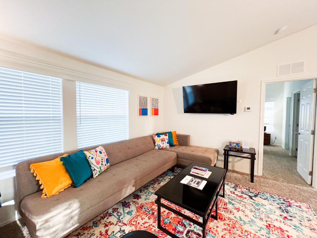 a living room with a couch and a flat screen tv at Ridgeview Oasis in Poway