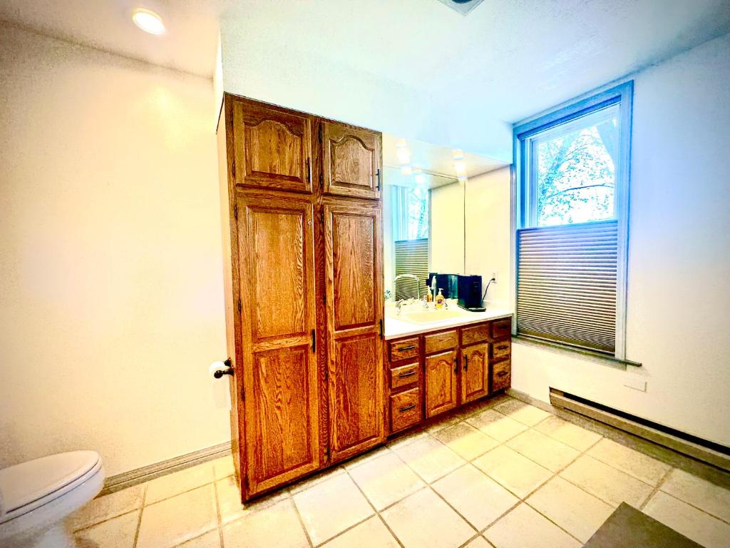 a bathroom with a toilet and a wooden door at The Second Story in Raton