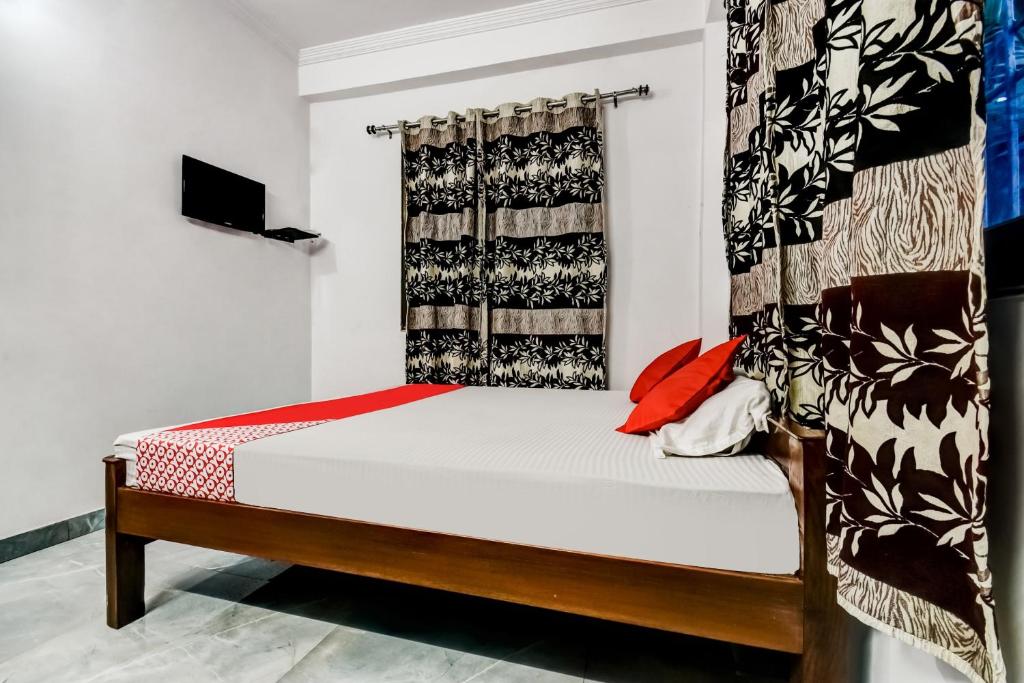 Кровать или кровати в номере OYO Flagship Hotel Capital Hill