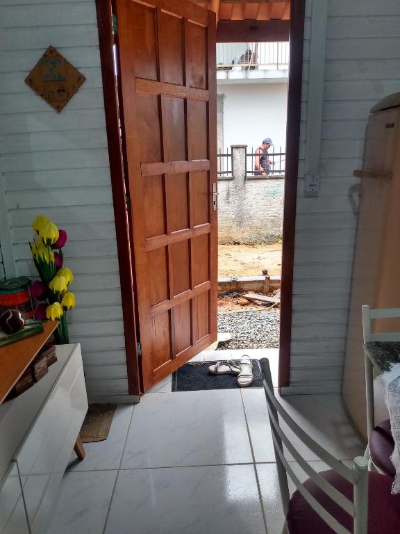 an open door to a house with a porch at Casa barra velha sc in Barra Velha