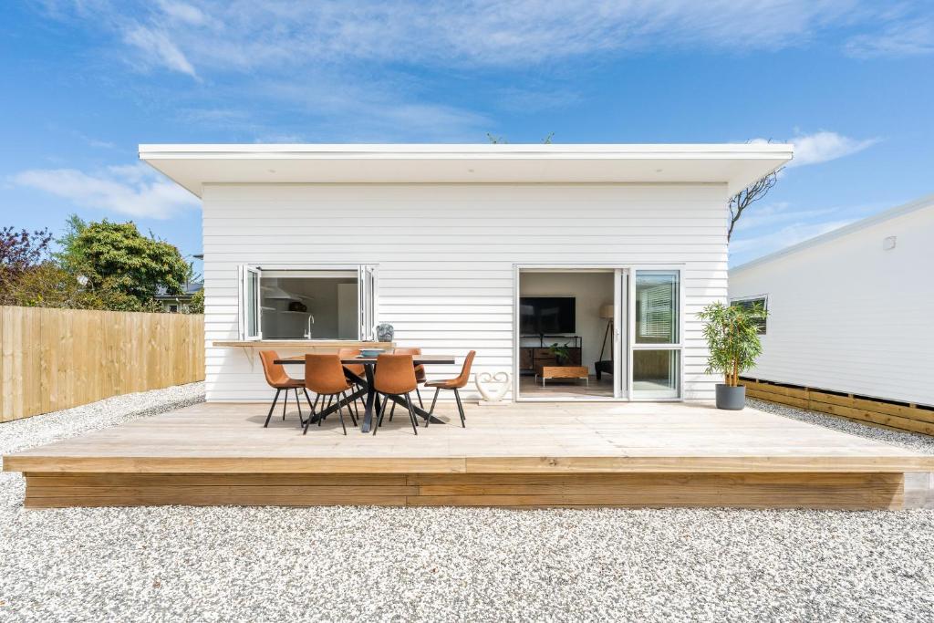 a patio with a table and chairs in front of a house at Close to Town & Lake - Taupo in Taupo