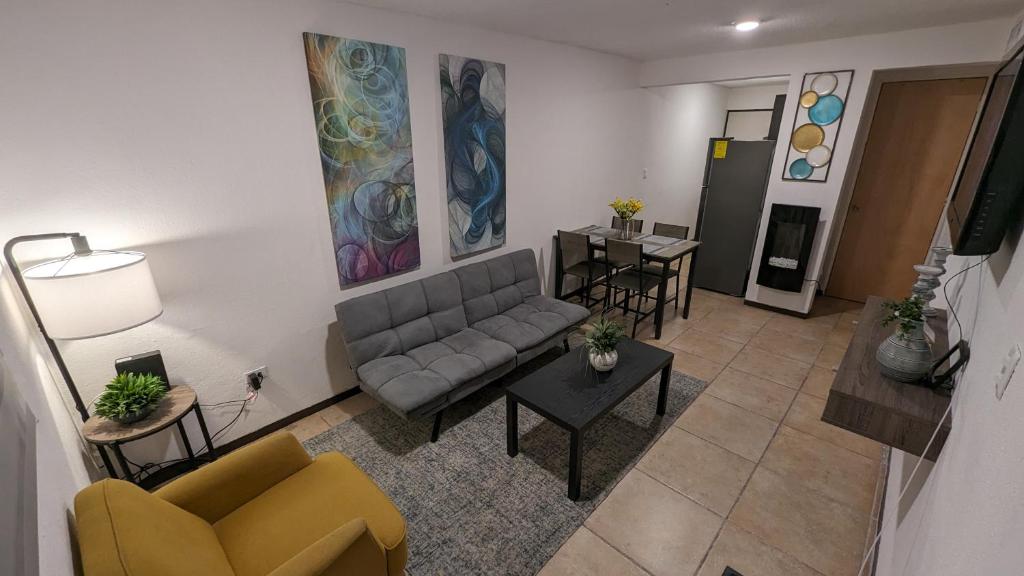 Acogedora Casa في سيوداد خواريز: غرفة معيشة مع أريكة وطاولة