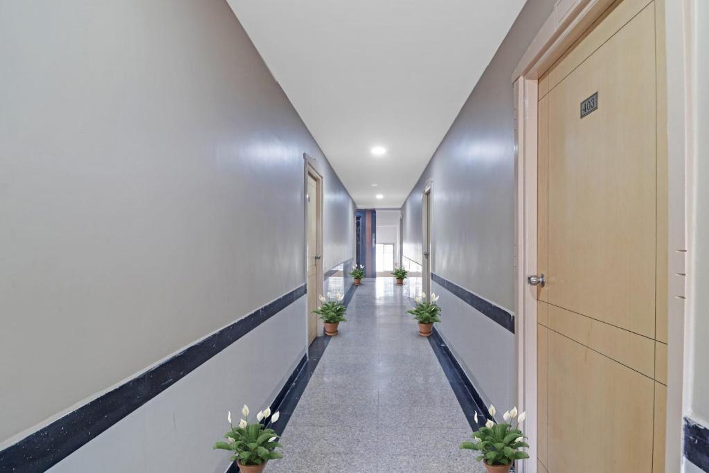 a corridor in a hospital with potted plants at Hotel Padmini Near Lakdikapool Metro Station in Hyderabad