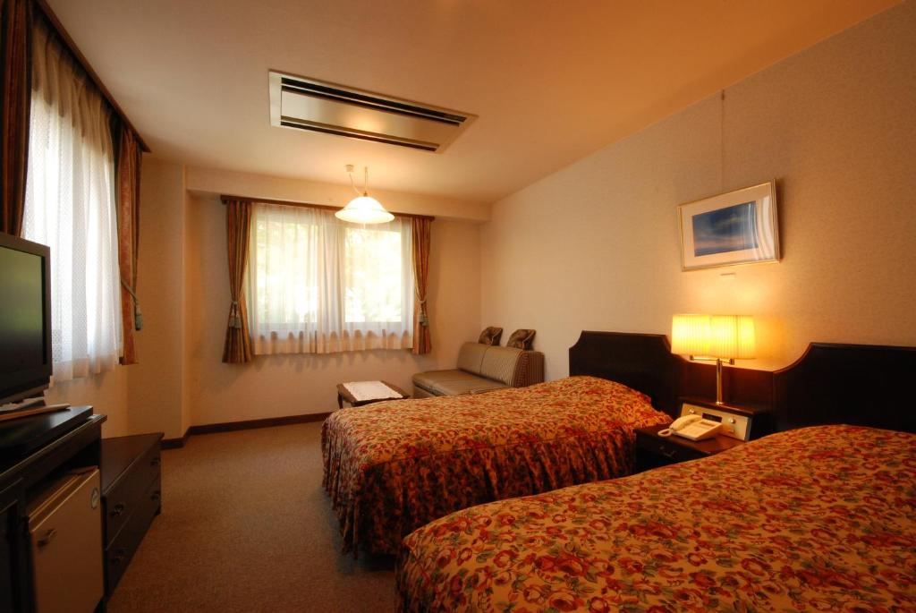Postel nebo postele na pokoji v ubytování Hotel Soyokaze