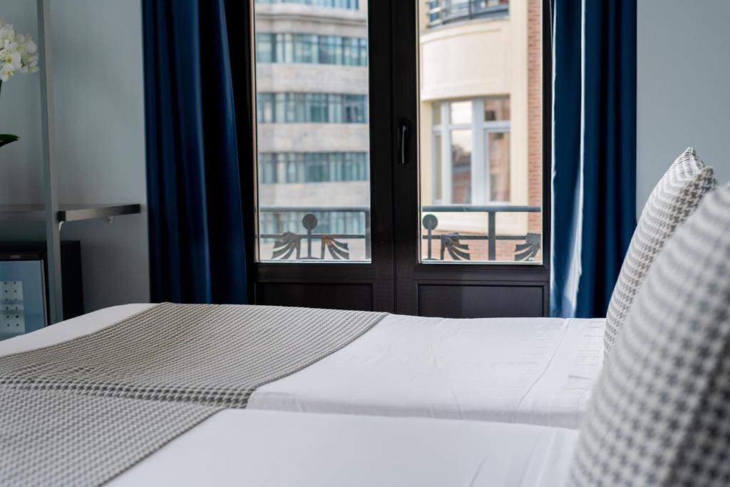 Postel nebo postele na pokoji v ubytování Hostal Carmen-Gran Vía