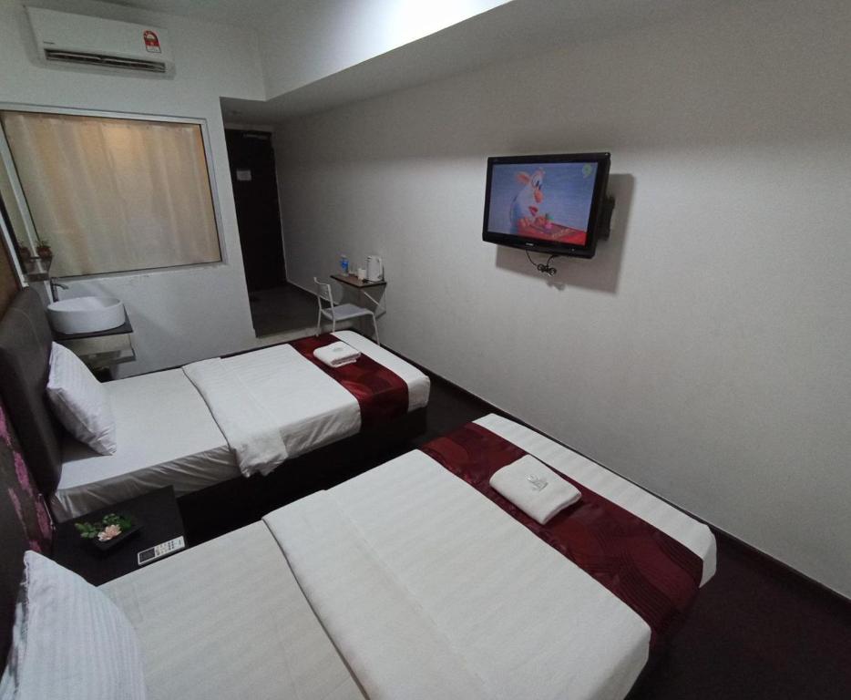 Postel nebo postele na pokoji v ubytování Warisan Hotel Kota Kinabalu