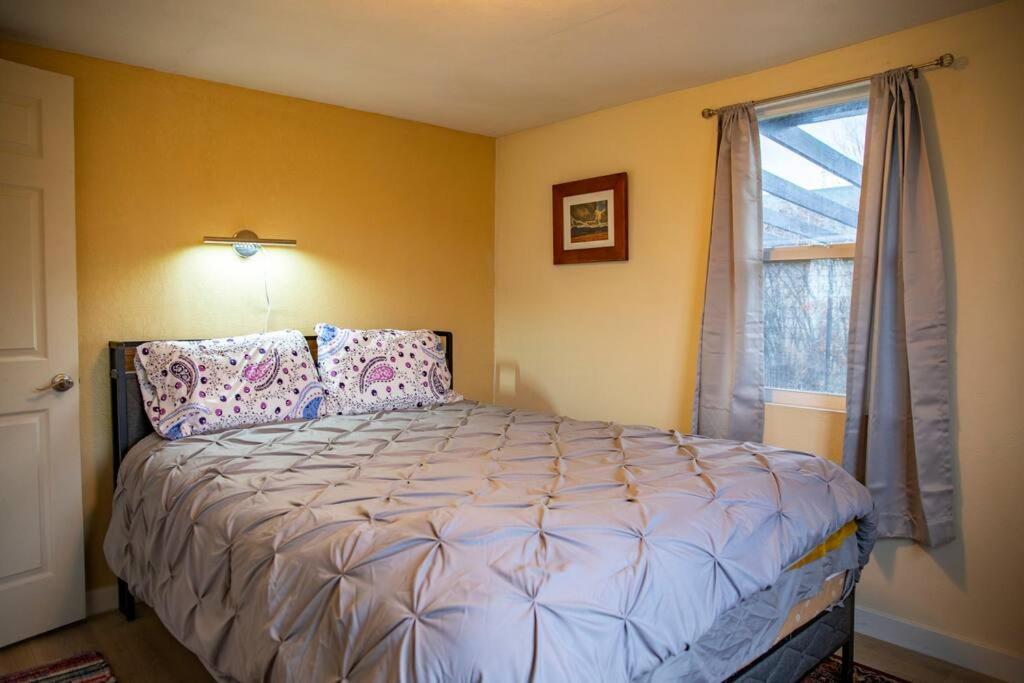 a bedroom with a bed and a window at 2 bed 1 bath cottage home in Price