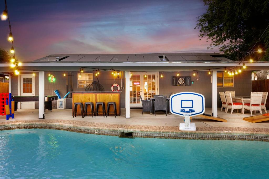 a swimming pool in front of a house at Home with pool and games in central San Antonio in San Antonio
