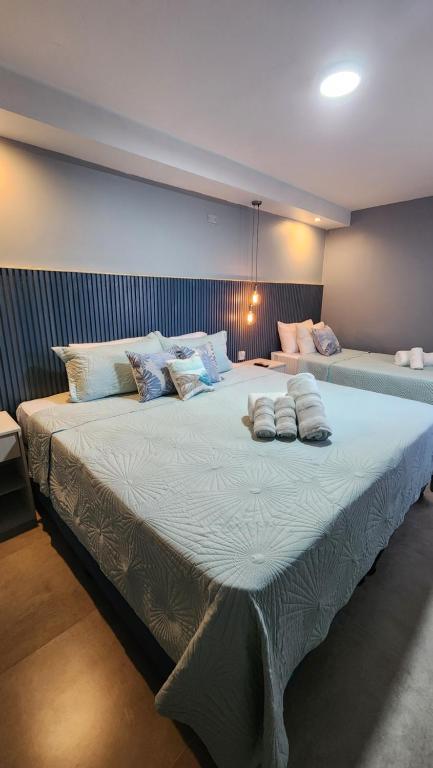 a large bed in a room with two pillows on it at Essencial Hotel & Spa in Mendoza