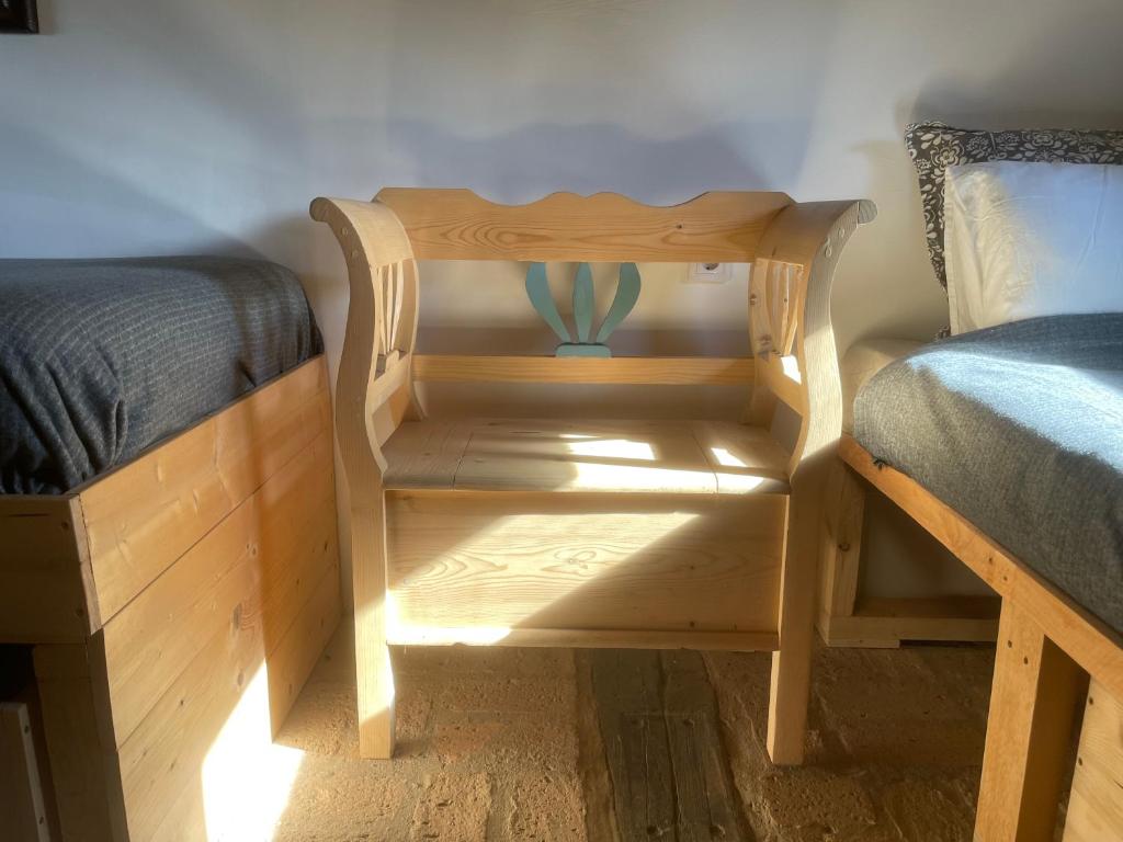 a bed and a night stand next to a bed and a table at Nature Lodge Csesztve in Csesztve