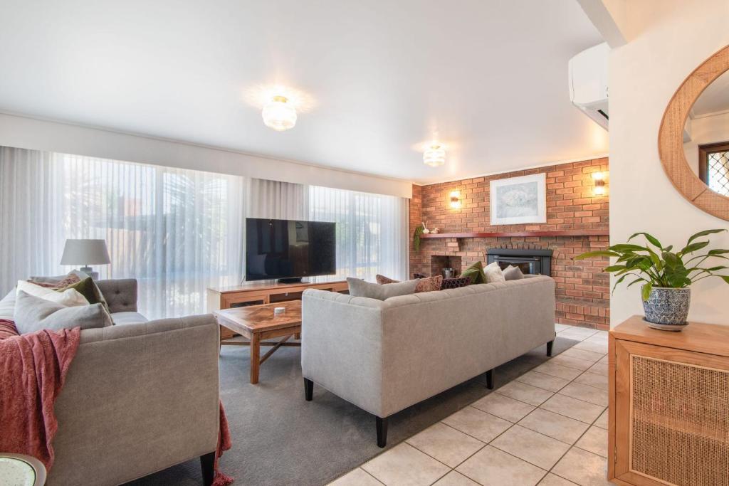 a living room with two couches and a tv at Arden Monte Vista in Rye