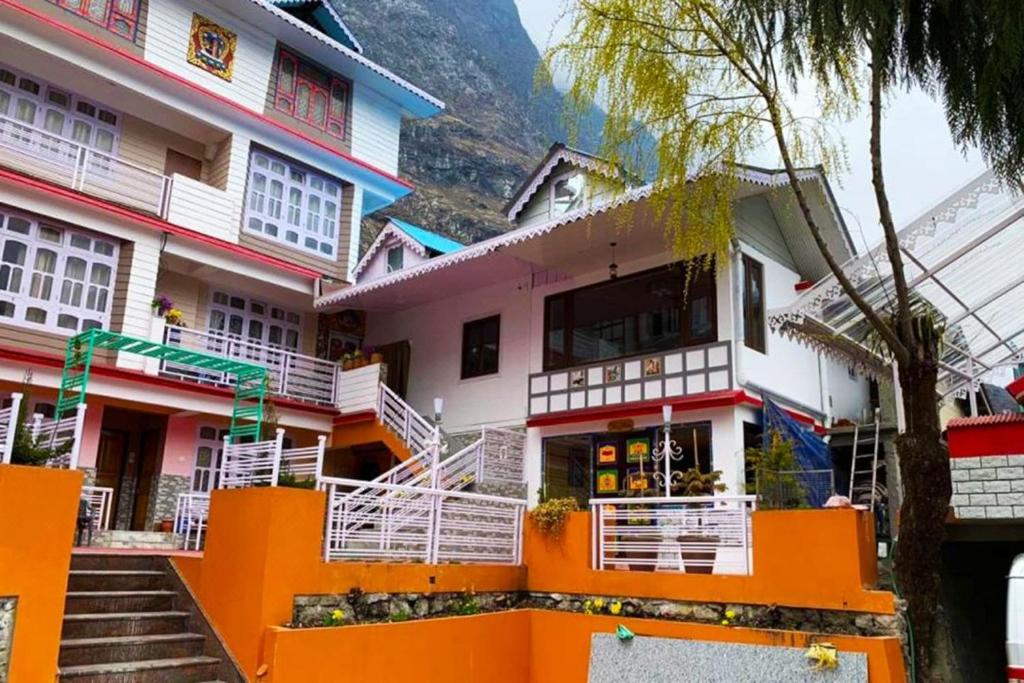 a building with stairs in front of it at Udaan Tashi Gakhil Resort in Lachung