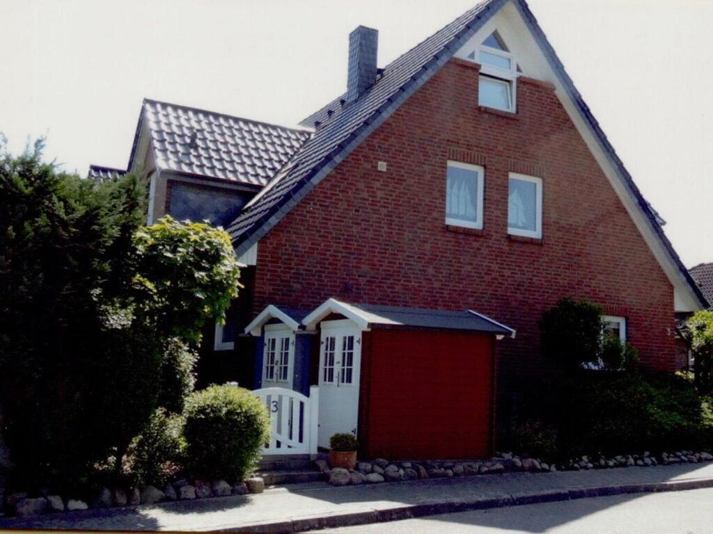 a red brick house with a red garage at Seebergweg Modern retreat in Maasholm-Bad