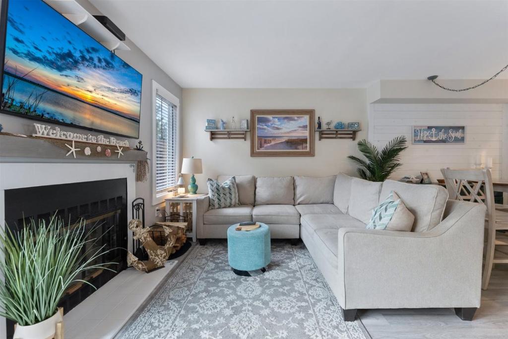 a living room with a couch and a fireplace at 114 Austin Ave, Unit 11 in Wildwood