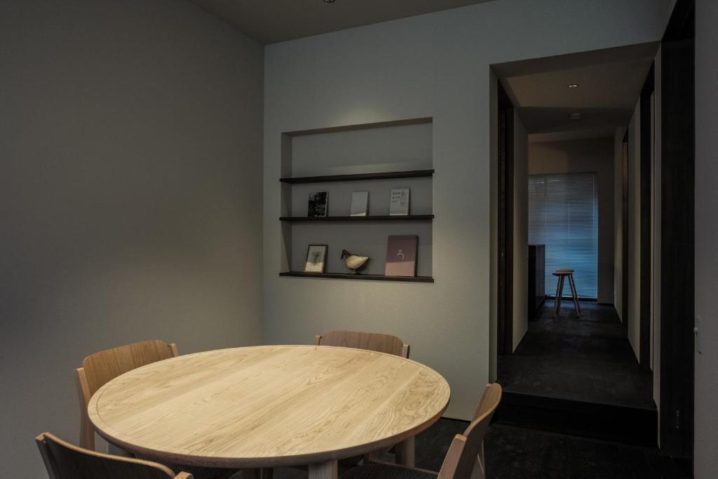 a dining room with a wooden table and chairs at SOUQ Renovated Townhouse in Himeji Quiet Market District in Himeji