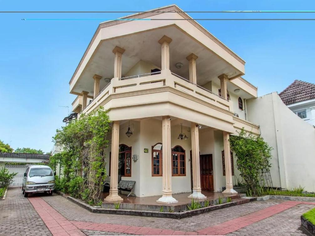 a house with a car parked in front of it at Guest House MW 46 by NmRooms in Demangan