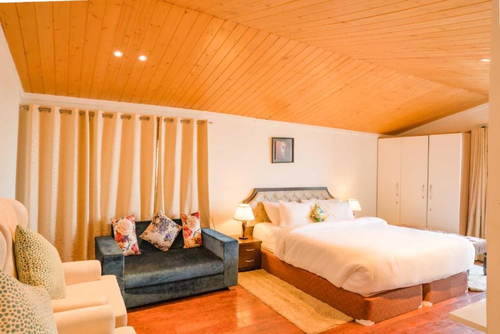 a bedroom with a king sized bed and a chair at Holiday In Homestay in Shimla