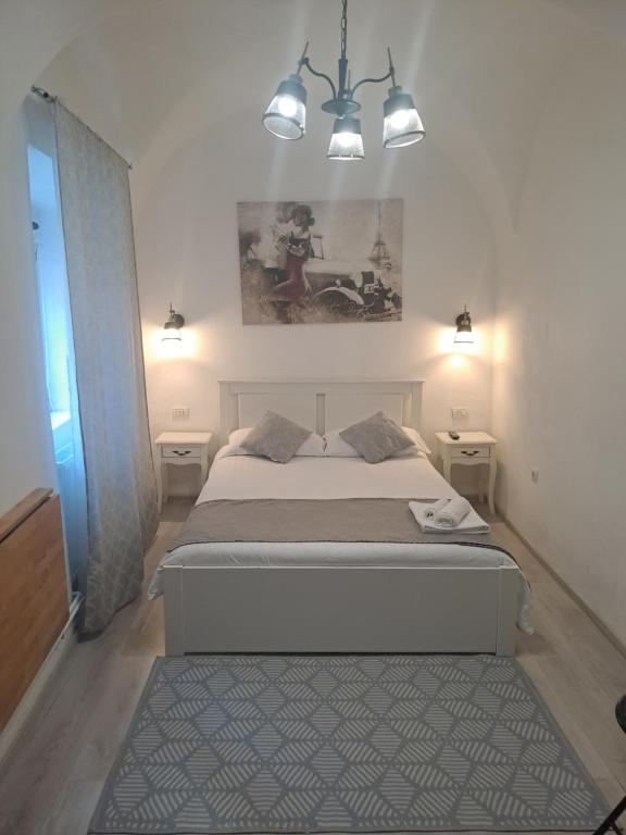 a bedroom with a bed with two lights on it at Garsoniera Vivere in Sibiu