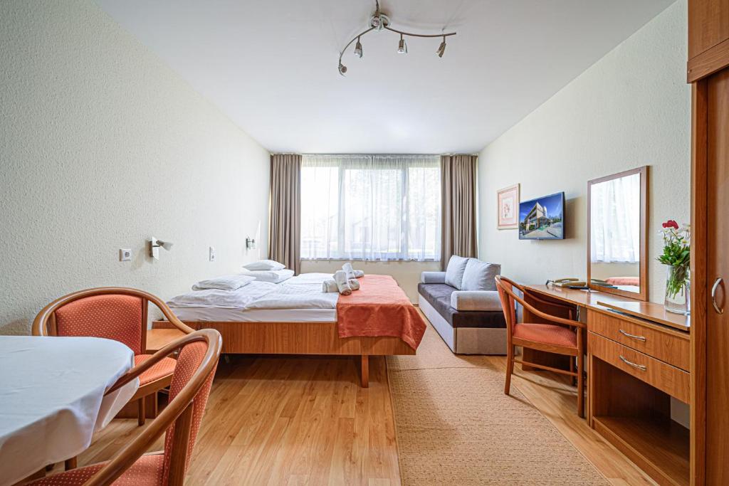 Łóżko lub łóżka w pokoju w obiekcie Apartman Hotel