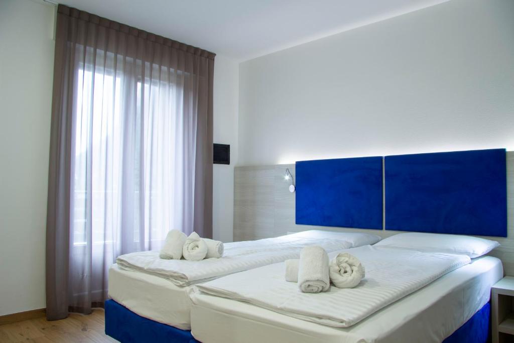 Postel nebo postele na pokoji v ubytování Liz Hotel & Apartments
