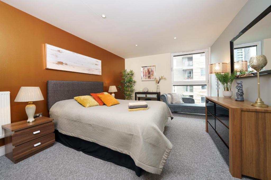 a bedroom with a bed and a living room at Dennison House in London