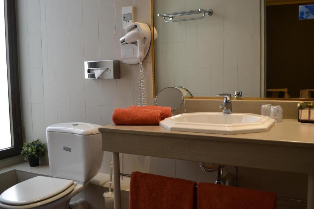 a bathroom with a toilet and a sink at Saint Ferréol in Marseille