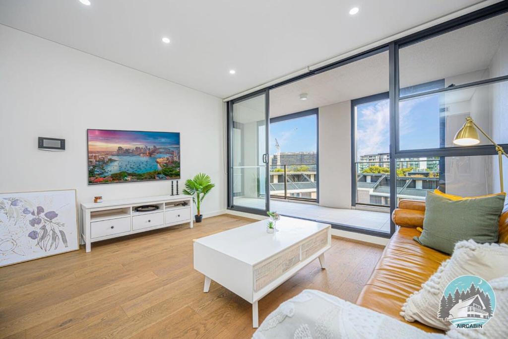 a living room with a couch and a table at Aircabin - Zetland - Lovely - 2 Beds Apt Free Park in Sydney
